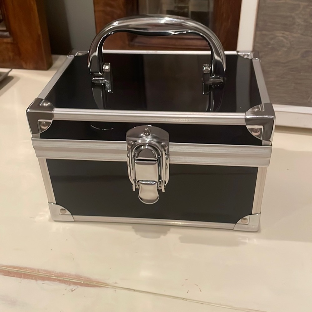 Compact black aluminum cosmetic storage case